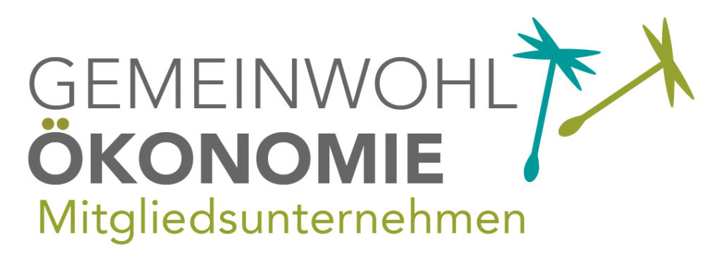 Writing "Gemeinwohlökonomie member company" and 2 seeds of the dandelion